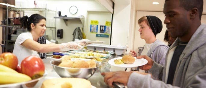 Serving food in a kitchen following good food hygiene practices