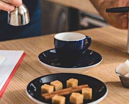 business plan for cupcake waiter preparing drinks with EHO checklist on counter