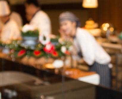 chefs prepare food in restaurant