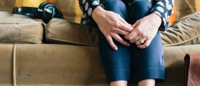 Woman at home sat on sofa