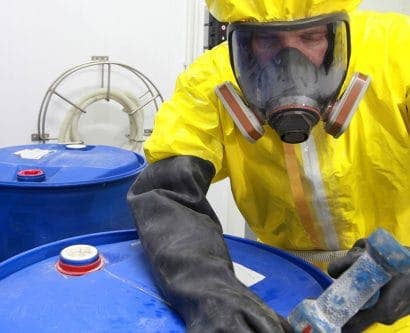 employee in PPE to deal with hazardous substances