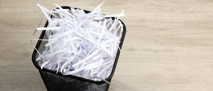Image shows a waste bin with shredded paper in