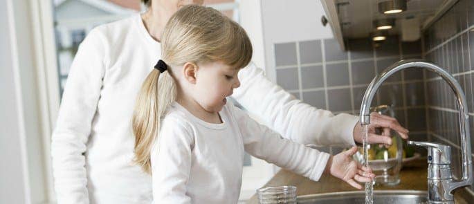 Parent teaching child the importance of handwashing