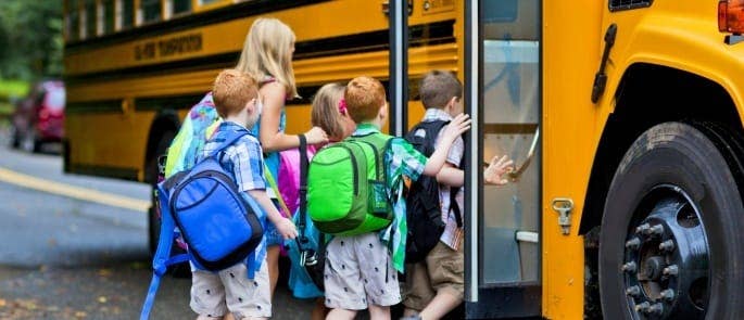Teacher and students getting on a bus