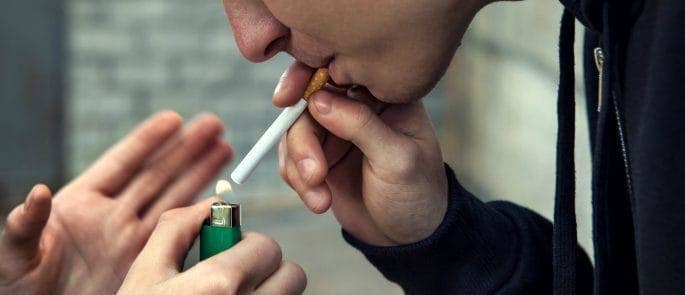 child displaying concerning behaviour by smoking