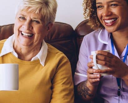 carer having cup of tea with service user and friend