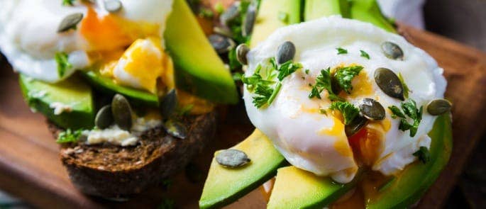 Avocado on toast with poached egg and sunflower seeds