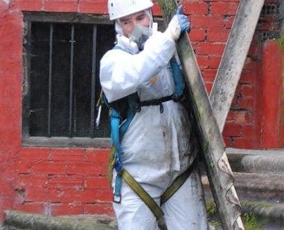workers handling pipes with asbestos