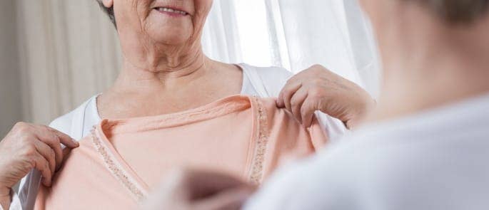 A nurse helping a patient chose their clothes