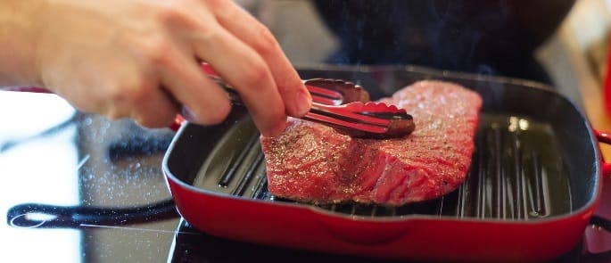 chef cooking raw meat