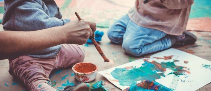Childminder painting with children