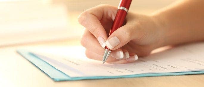 Woman writing a record of a safeguarding concern