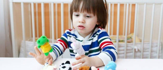Child playing with finger puppets