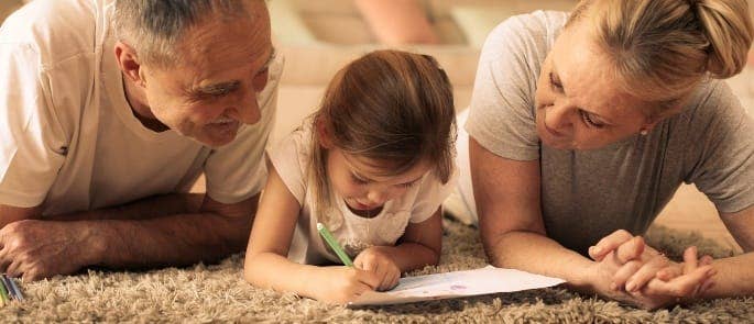 Parents watching their child with dyslexia write