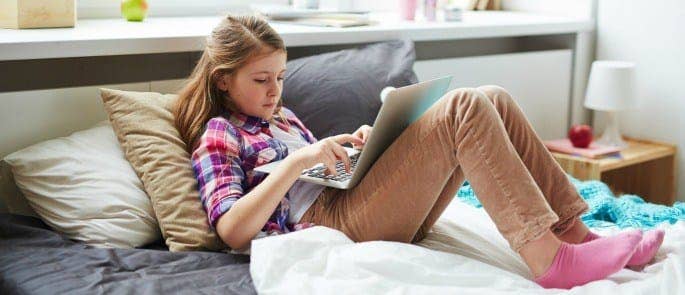 young girl on laptop using twitter