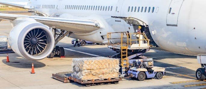 Man loading cargo onto an aeroplane