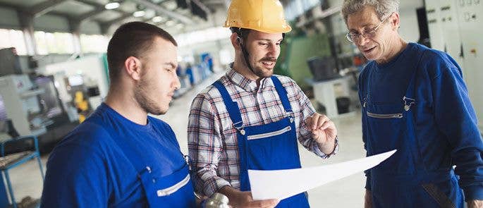 Construction workers speaking about plans