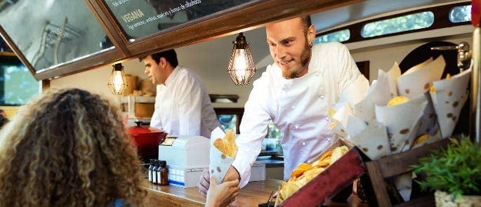 man serving food in a food truck