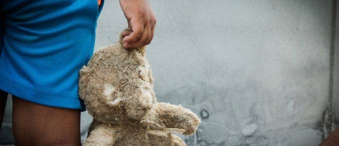 Child holding teddy