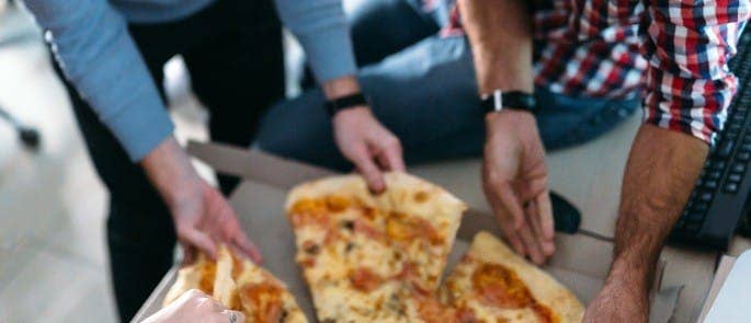 image of friends sharing pizza