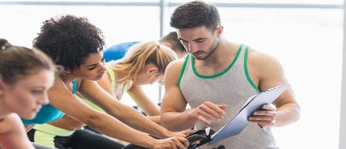 gym manager assessing safety of equipment