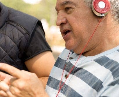 carer listens to music with service user