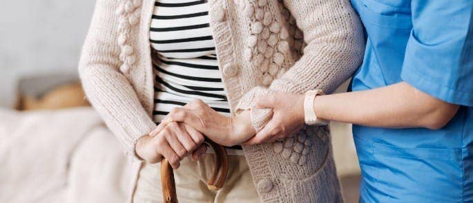 A nurse assisting a care home resident