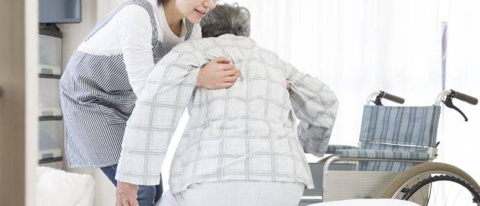 A carer assisting a resident in a care home