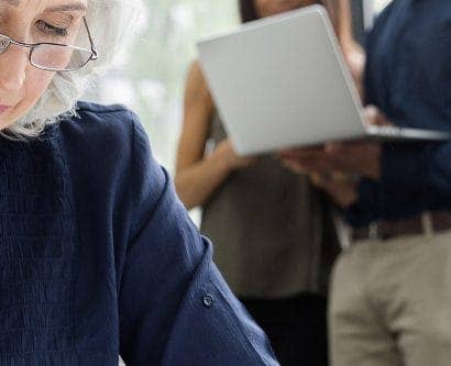 pensive older employee at computer