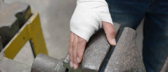 Worker with a hand bandage after a workplace injury