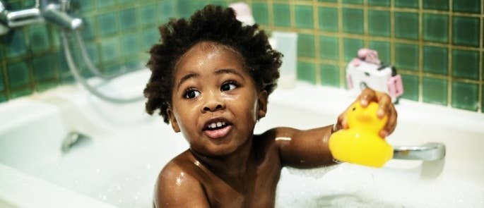A child with a rubber duck in the bath