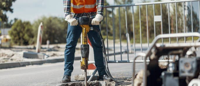 Worker using pneumatic drill