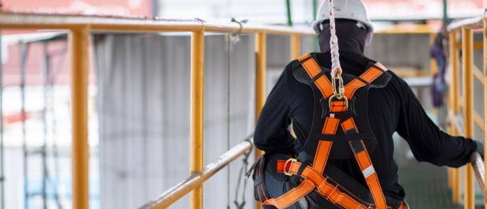 Worker wearing safety harness at height