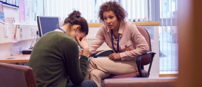 Teacher and headteacher discussing a safeguarding concern