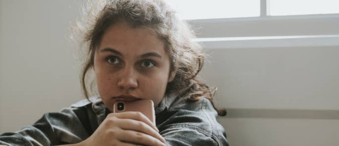 Worried teenage girl with phone