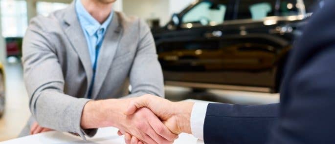 shaking hands purchasing car on credit