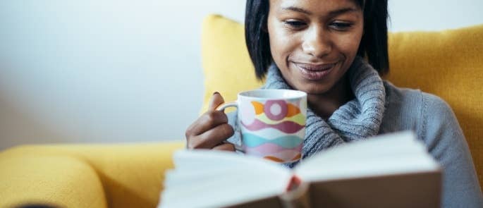 woman drinking tea and reading book