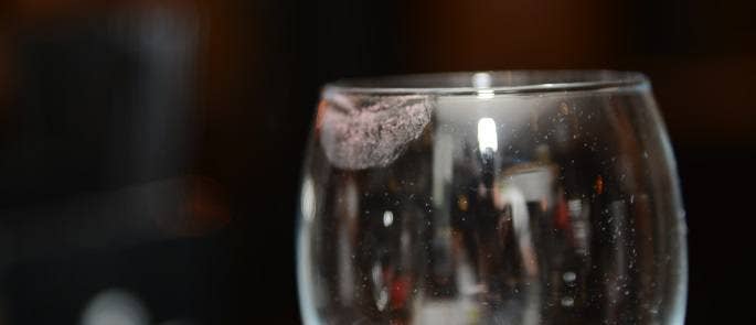 Importance of a cleaning schedule shown by lipstick on a dirty glass in a pub