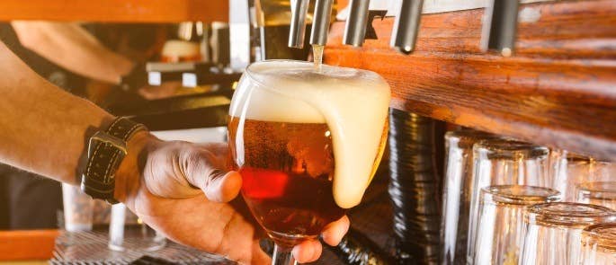 Poor bar techniques can lead to over pouring and a lot of wastage shown with an overflowing pint