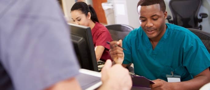 Nursing staff writing information for handover