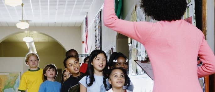 Teacher instructing students to line up during a school fire drill