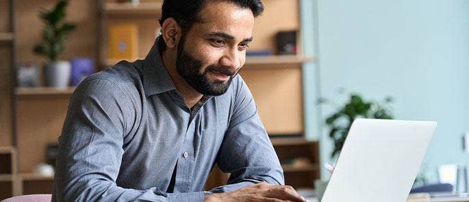 Member of staff looking on his laptop