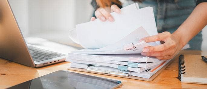 Teacher looking through papers on desk