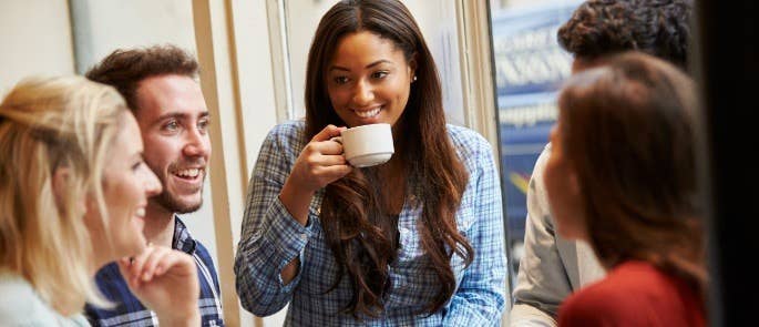 Group of friends drinking coffee in cafe