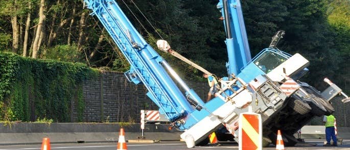 Construction equipment falling over on the road causing a hazard.