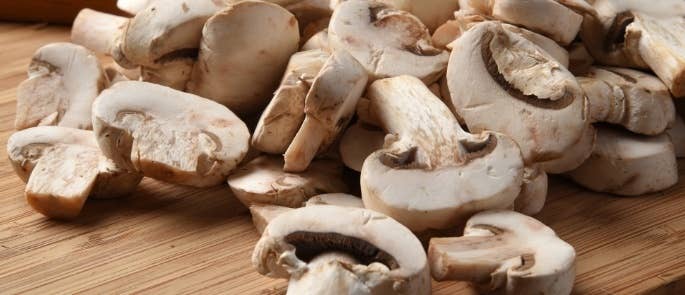 Raw mushrooms on a cutting board