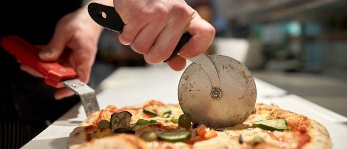 Chef cutting a pizza