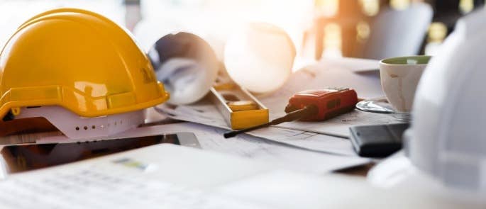 Contractor's equipment and hard hats on a table