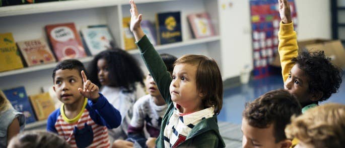 School children with their hands up