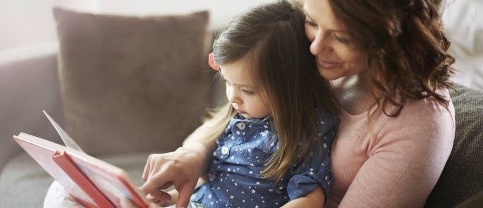 Mother reading aloud with her daughter